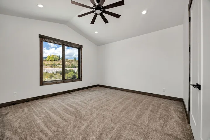 Unfurnished room featuring light carpet, ceiling fan, and recessed lighting