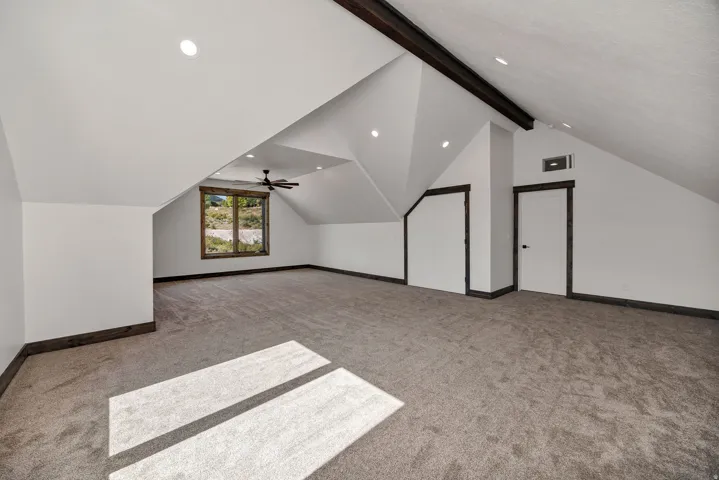 Bonus room with light colored carpet, beamed ceiling, recessed lighting, and ceiling fan
