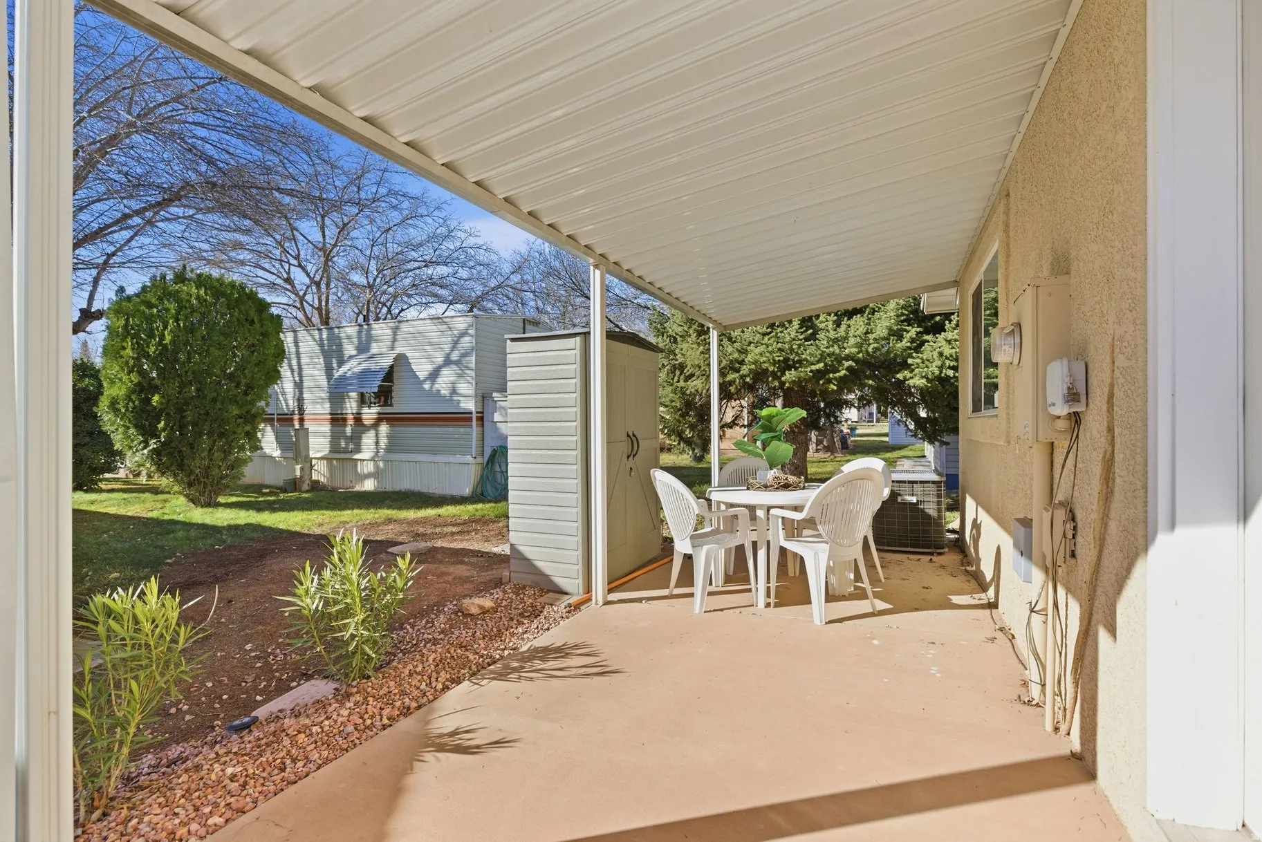 View of patio featuring outdoor dining space and a shed