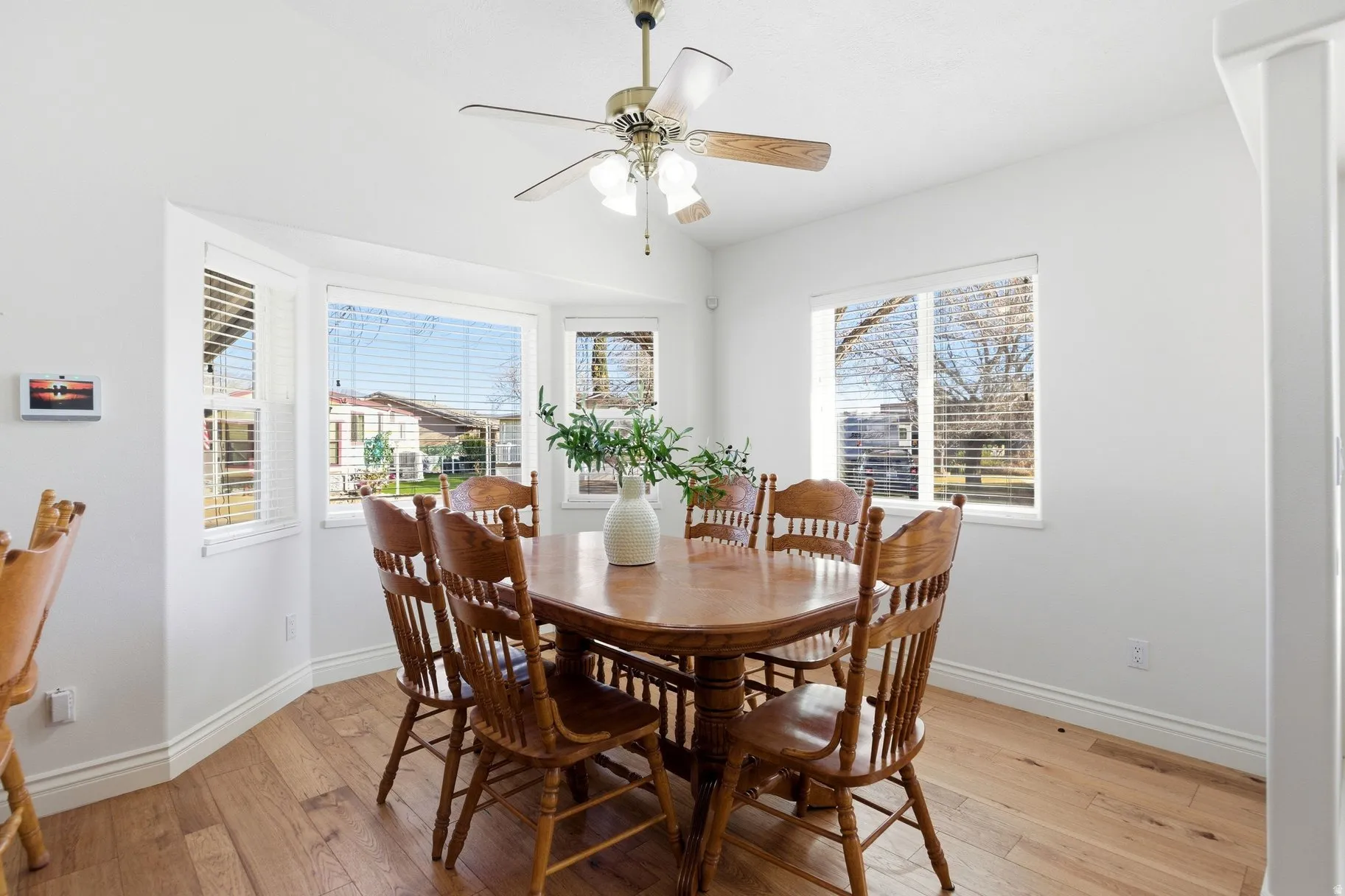 Dining area featuring light wood-style floors and a ceiling fan