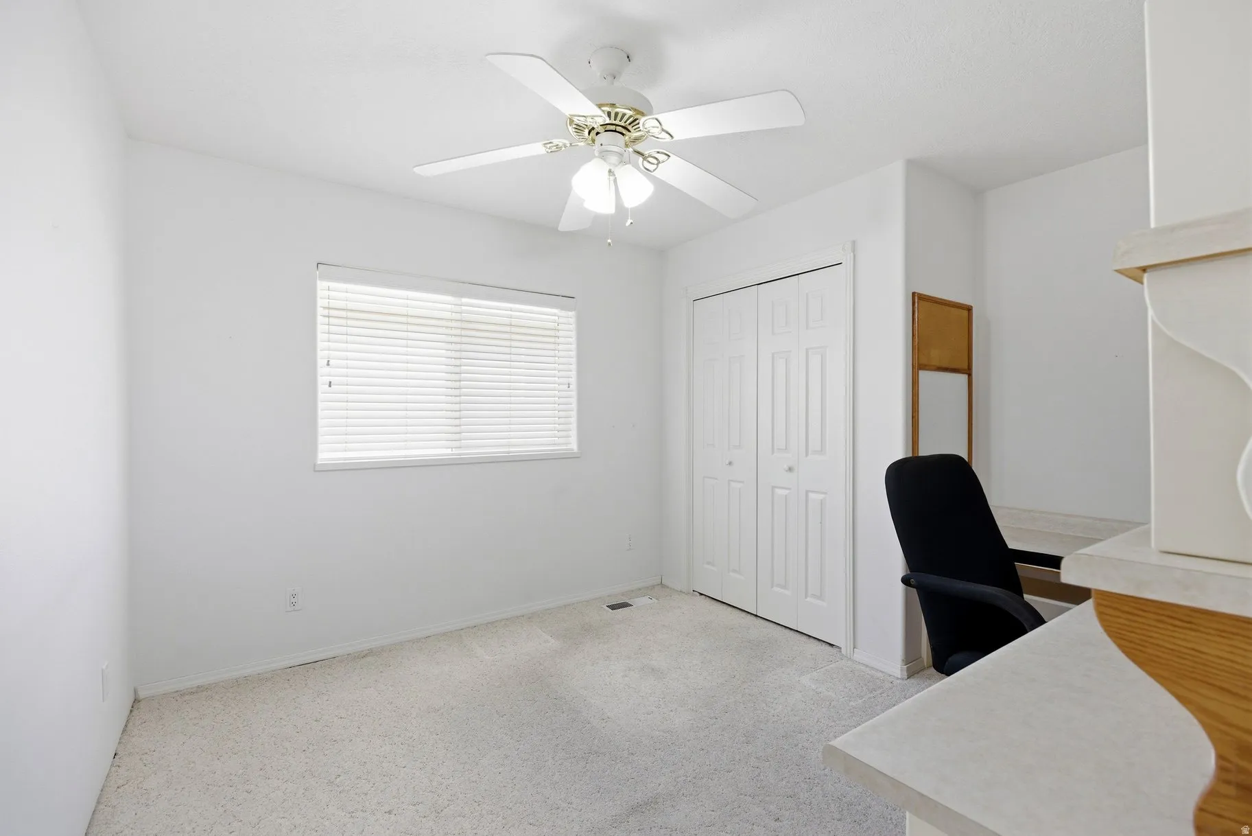 Office featuring light carpet and a ceiling fan