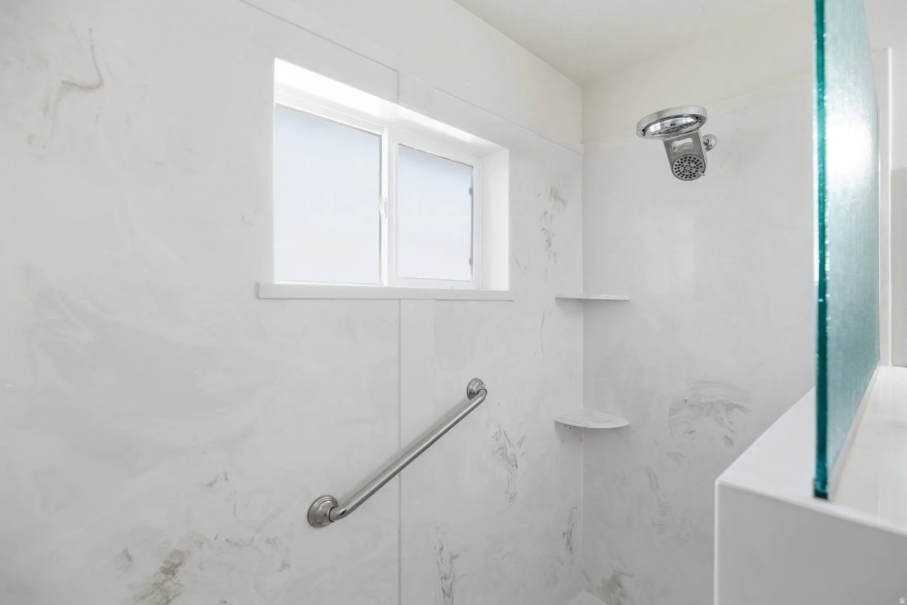 Bathroom with a marble finish shower