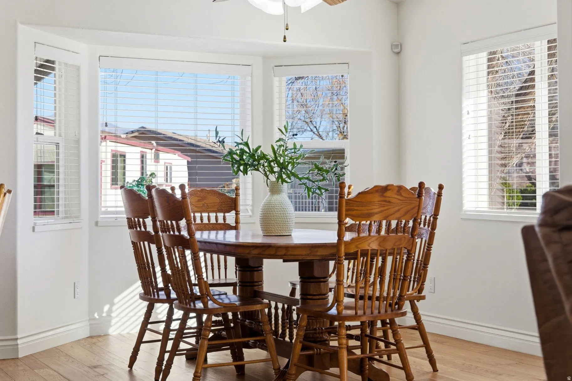 Dining space featuring a ceiling fan, light wood-style floors, and plenty of natural light