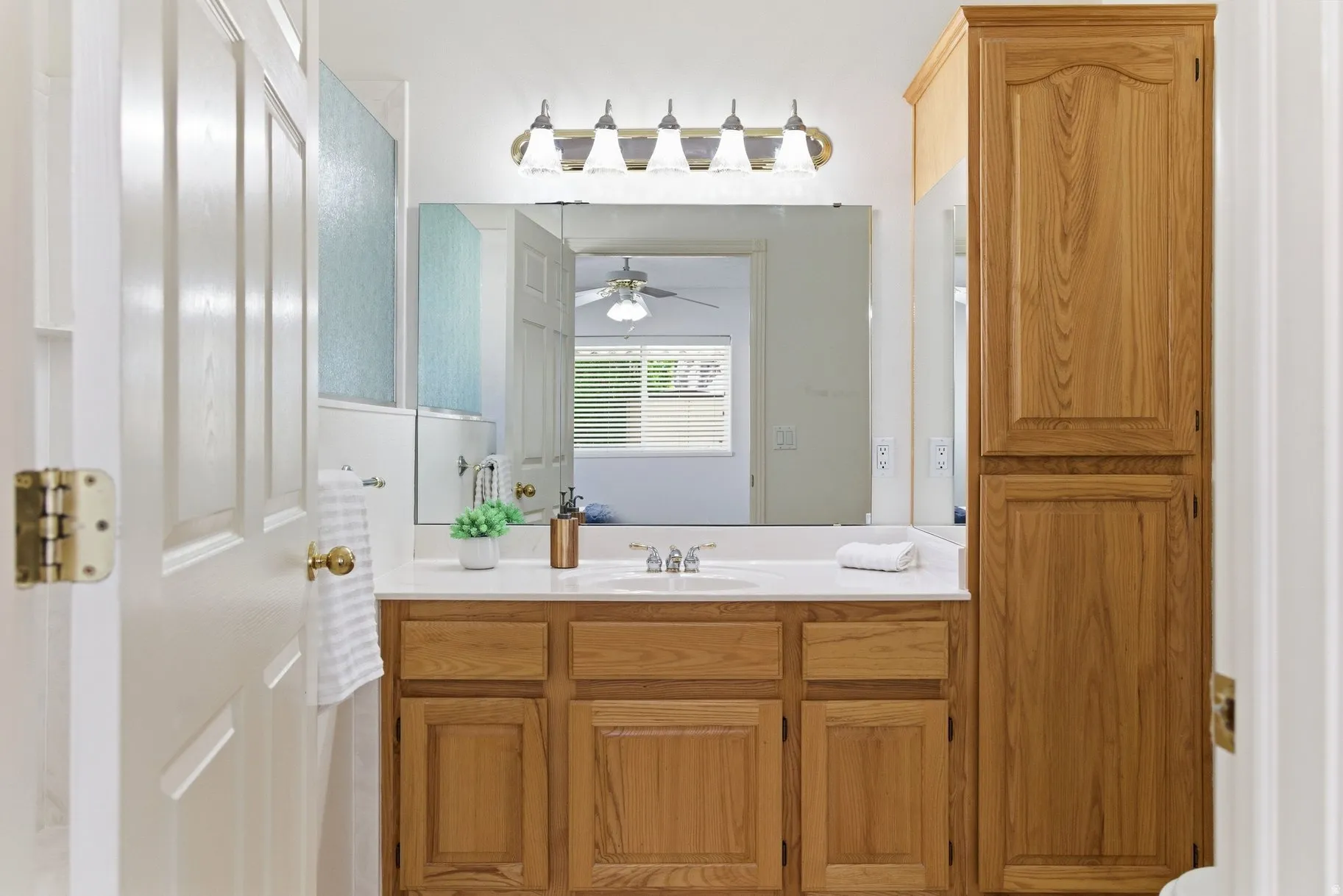 Bathroom featuring vanity and ceiling fan