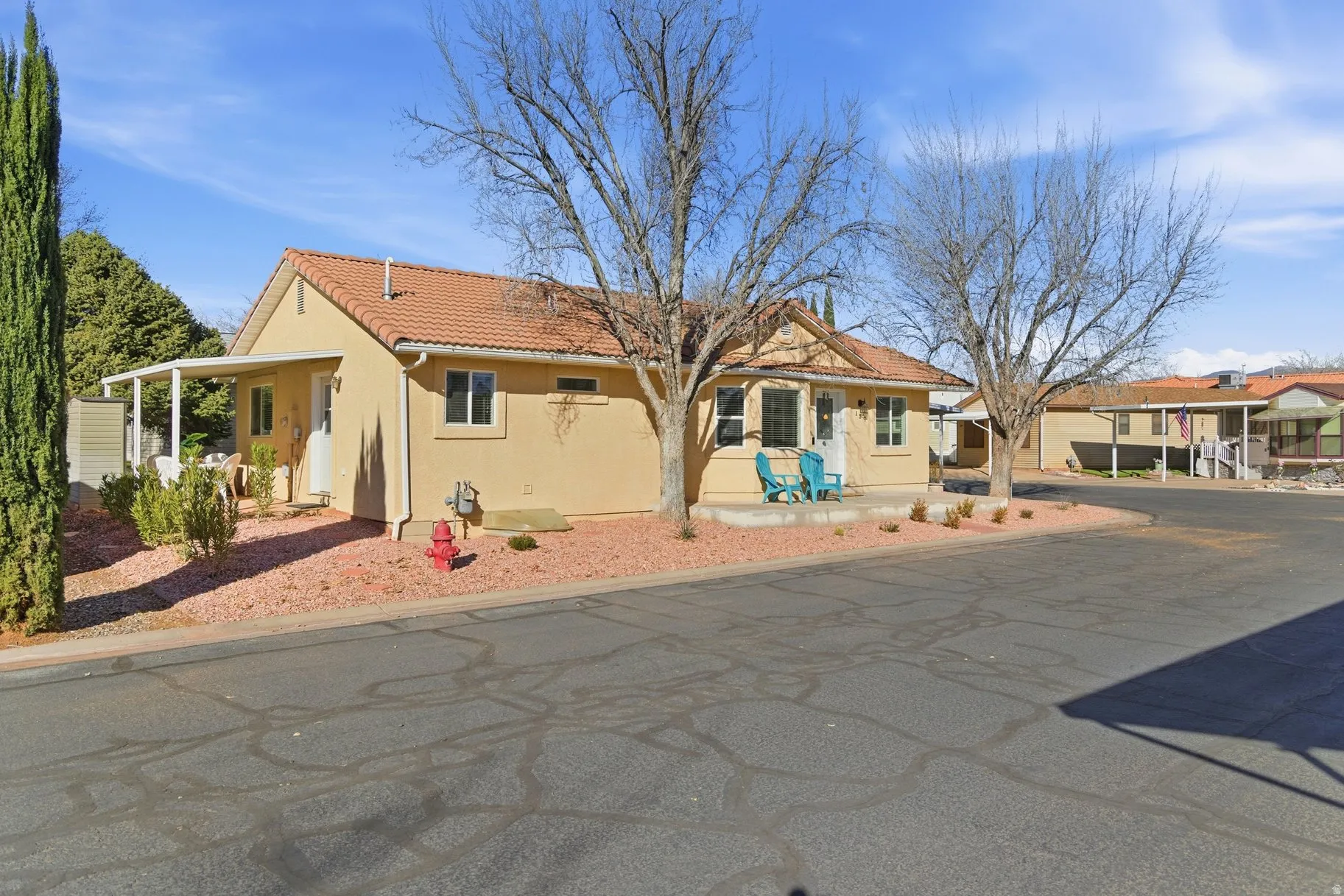 View of front facade with a tile roof and stucco siding