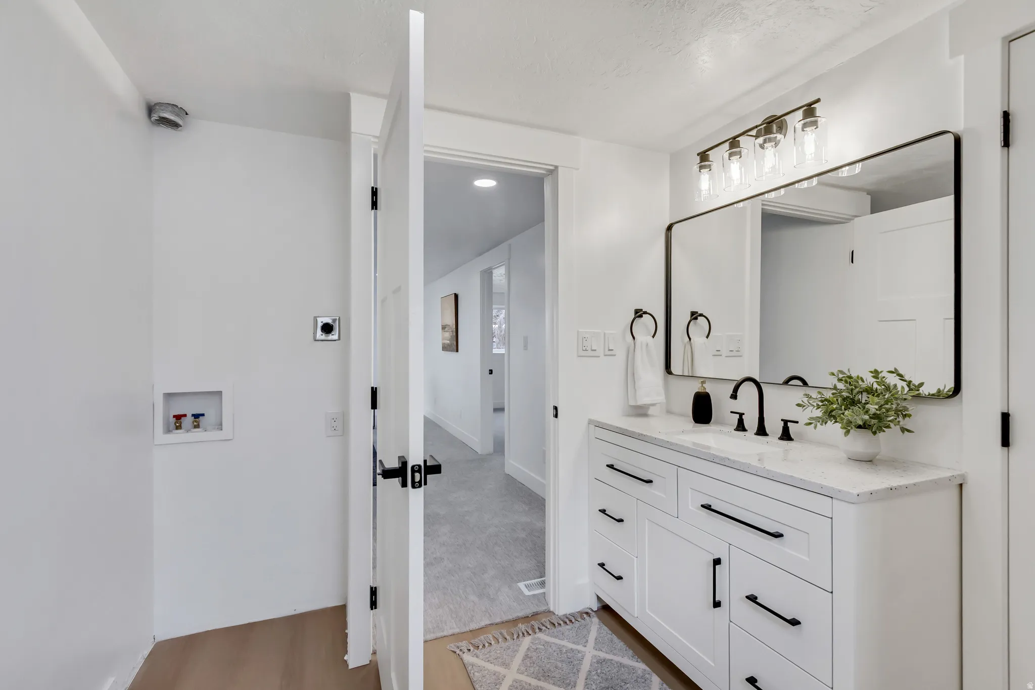 Bathroom featuring vanity and light wood-type flooring