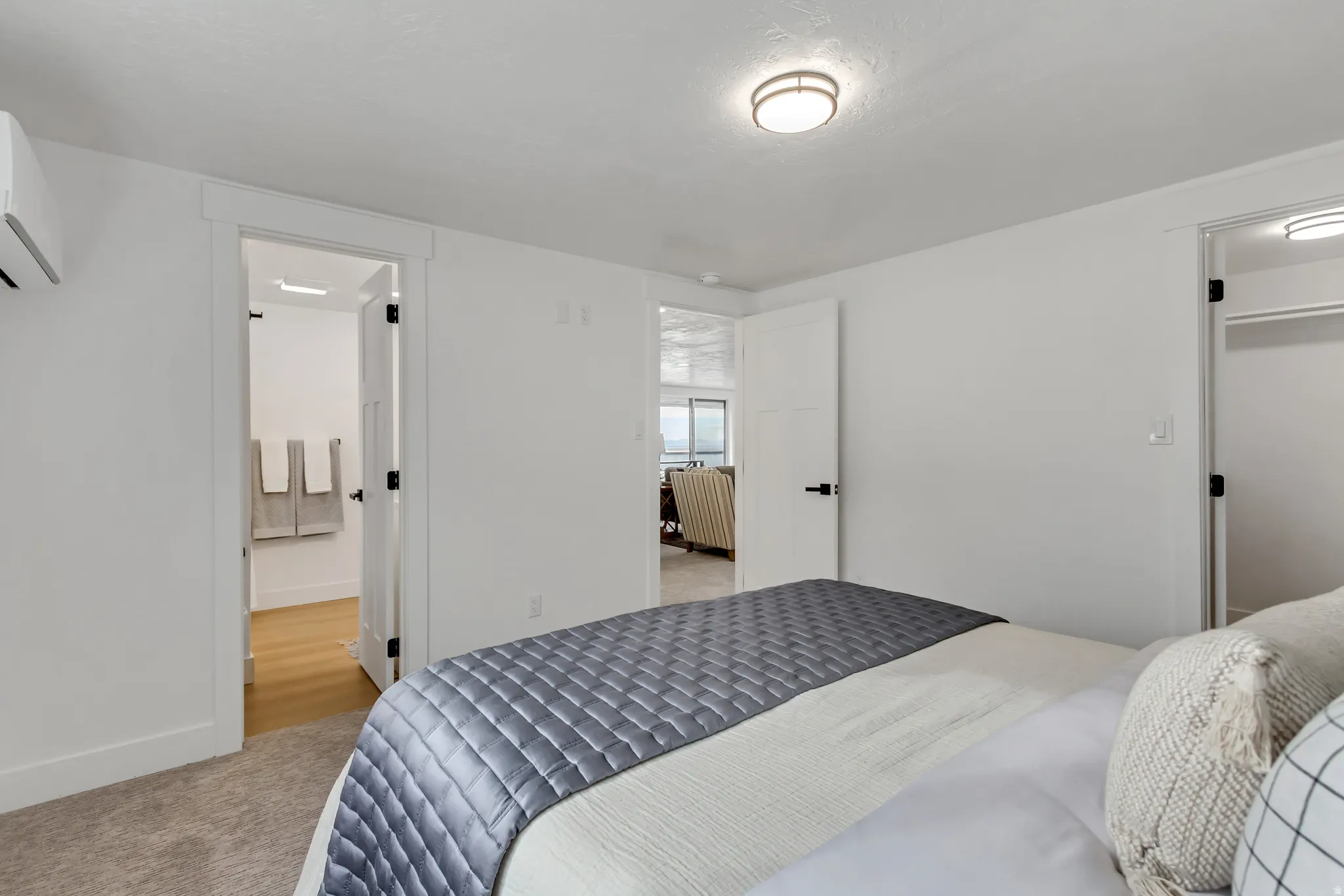 Bedroom featuring light carpet and a mini split for heating / cooling