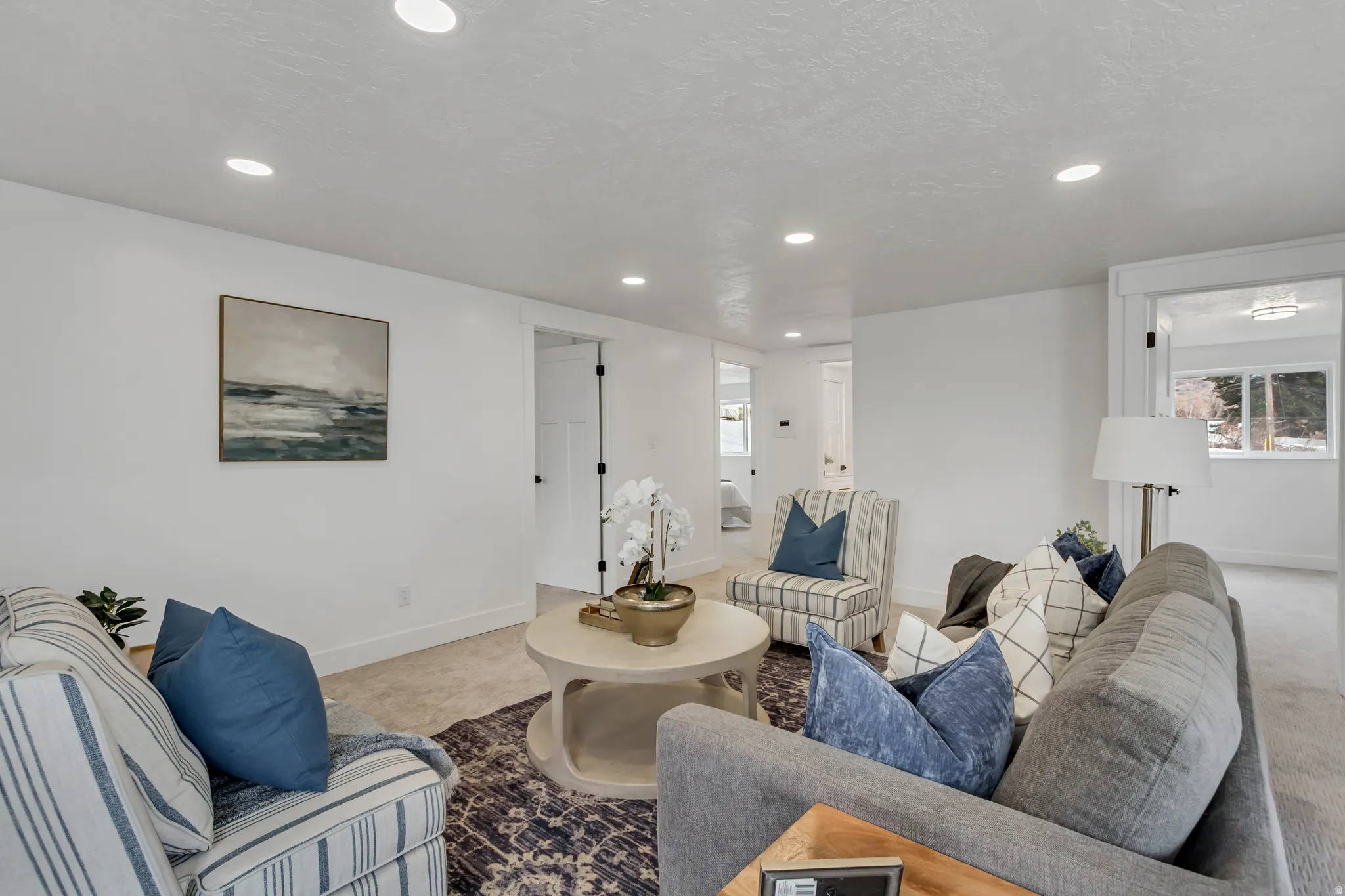 Carpeted living room featuring baseboards and recessed lighting