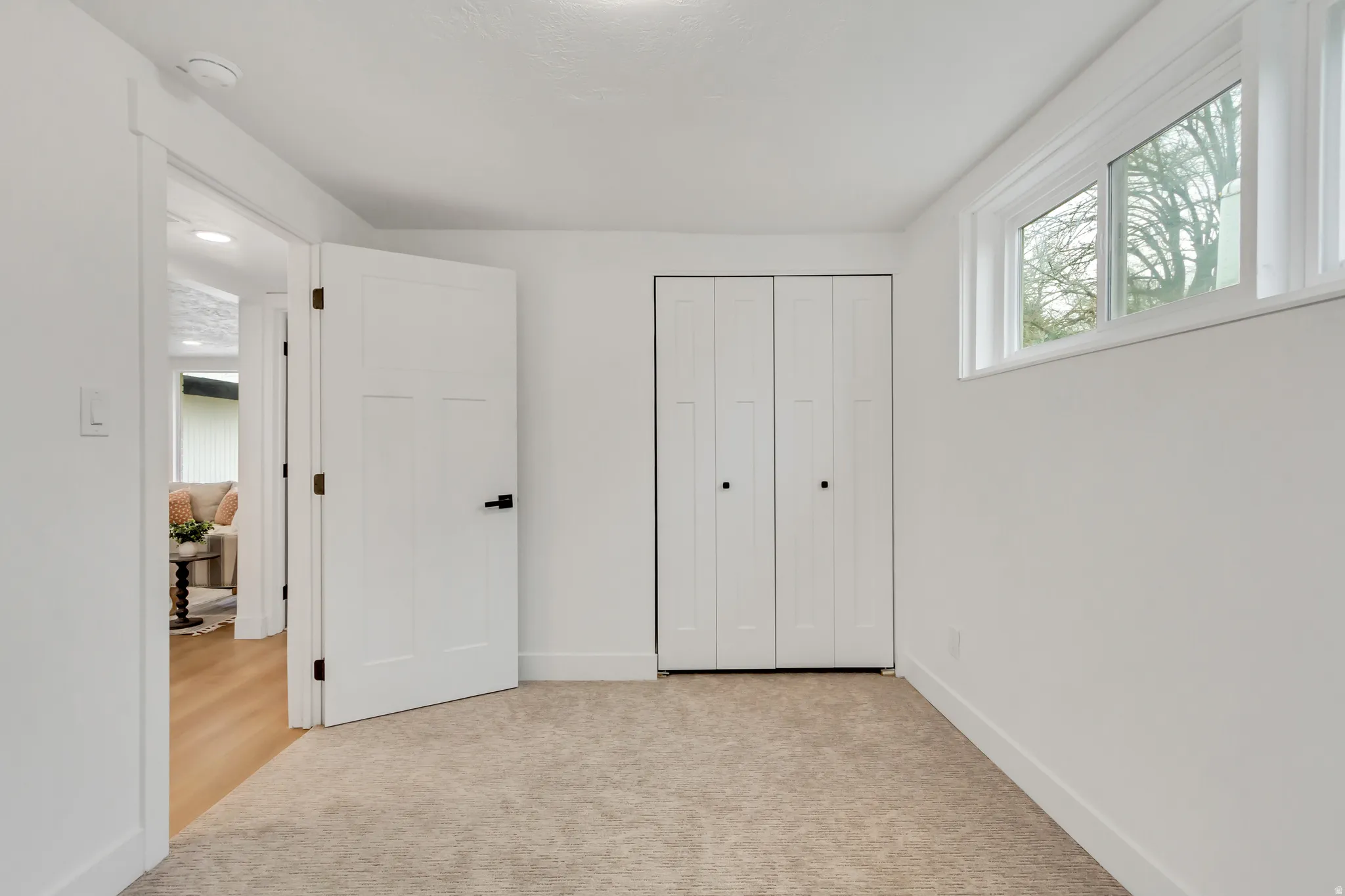 Unfurnished bedroom featuring light colored carpet and a closet