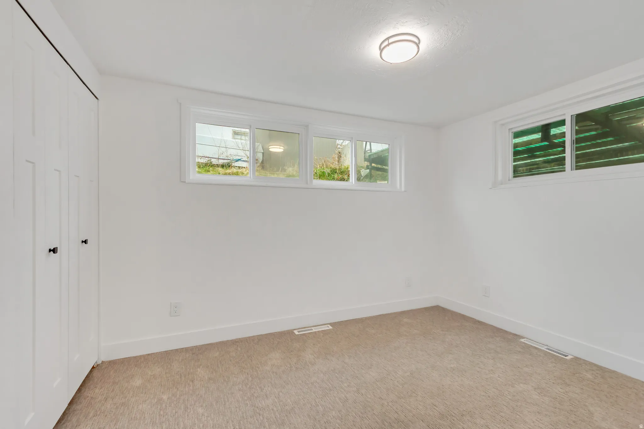 Unfurnished bedroom with a closet and light colored carpet