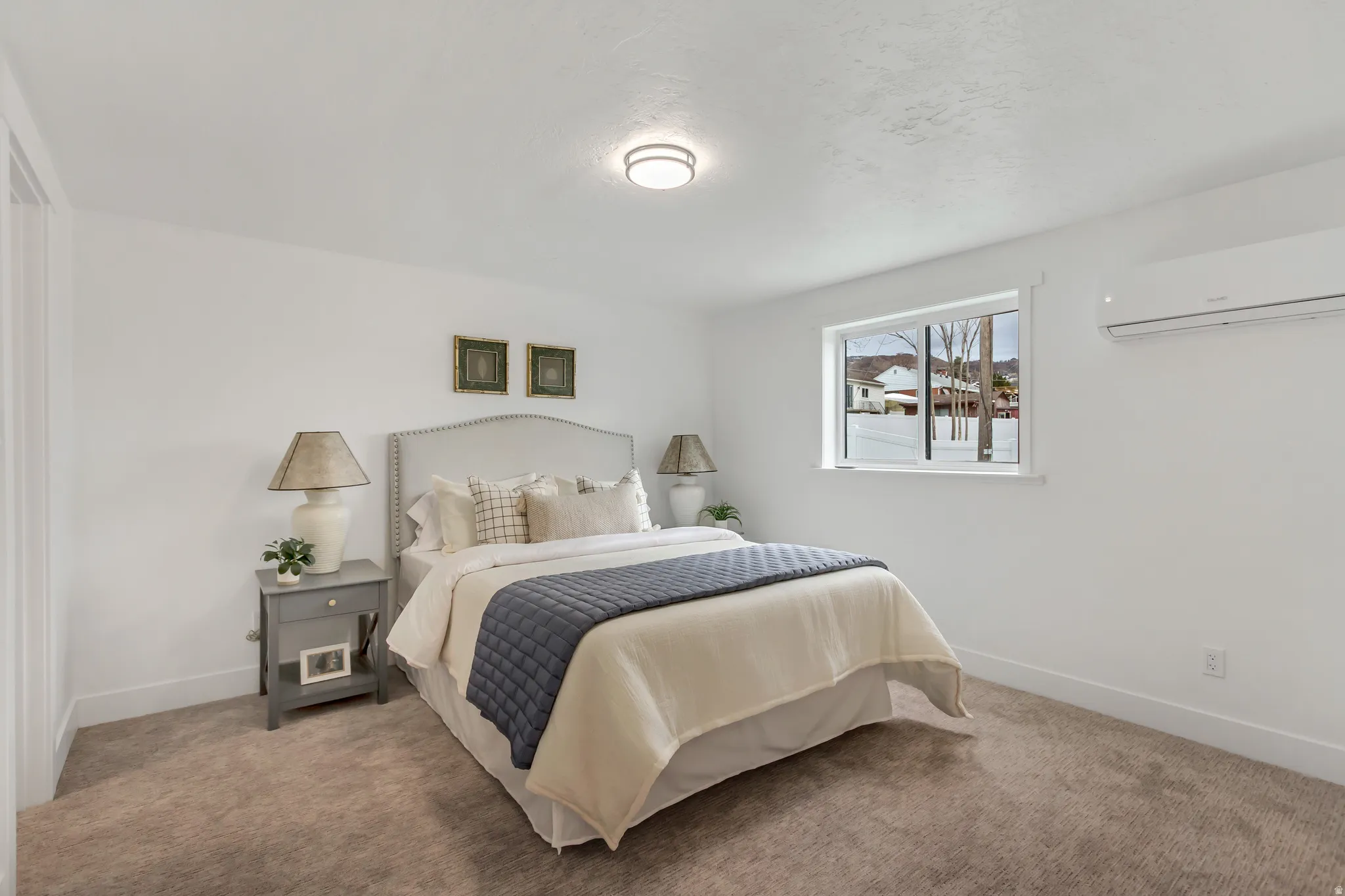 Bedroom with a mini split for heating / cooling and carpet