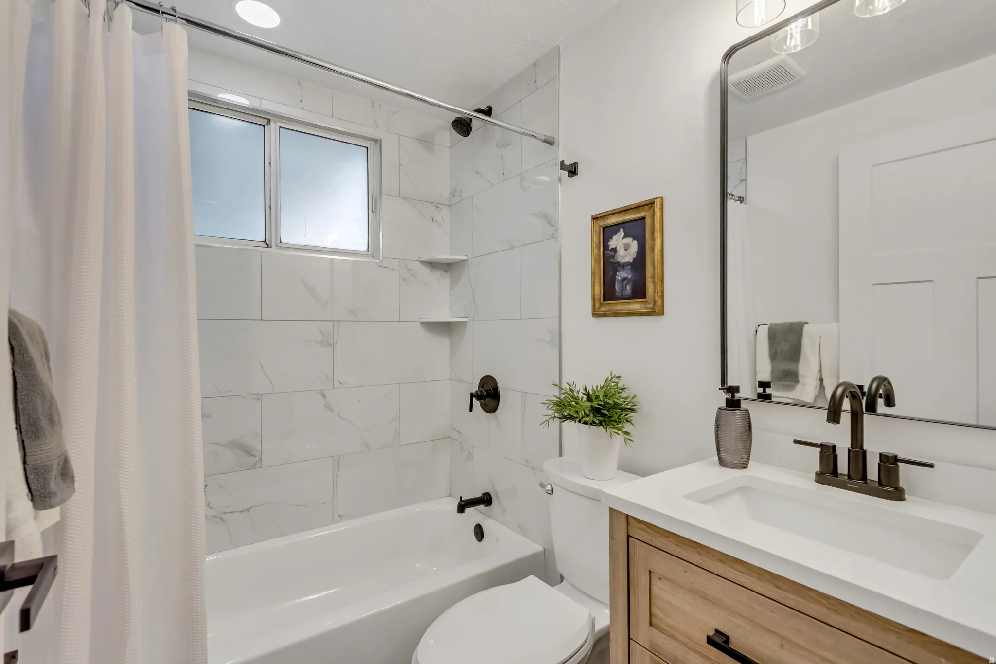 Bathroom with vanity and shower / bath combo