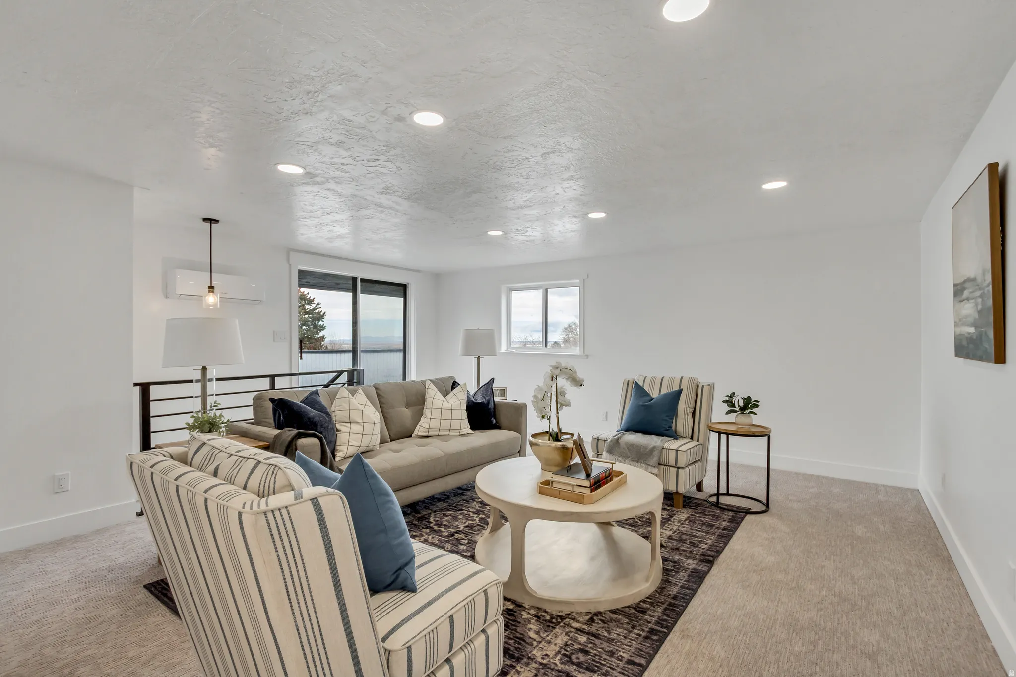 Living area featuring light colored carpet and recessed lighting