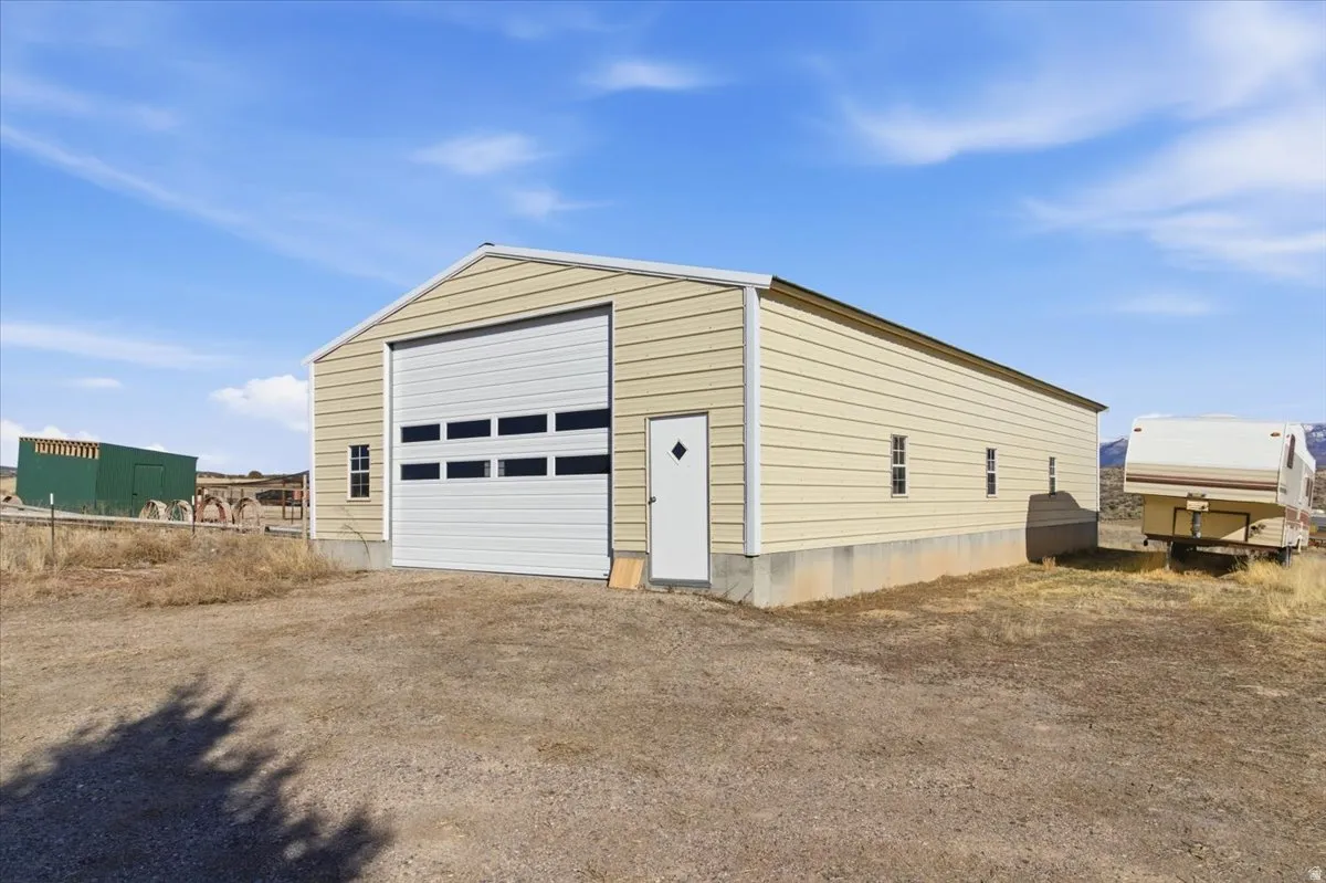 Detached garage with dirt driveway