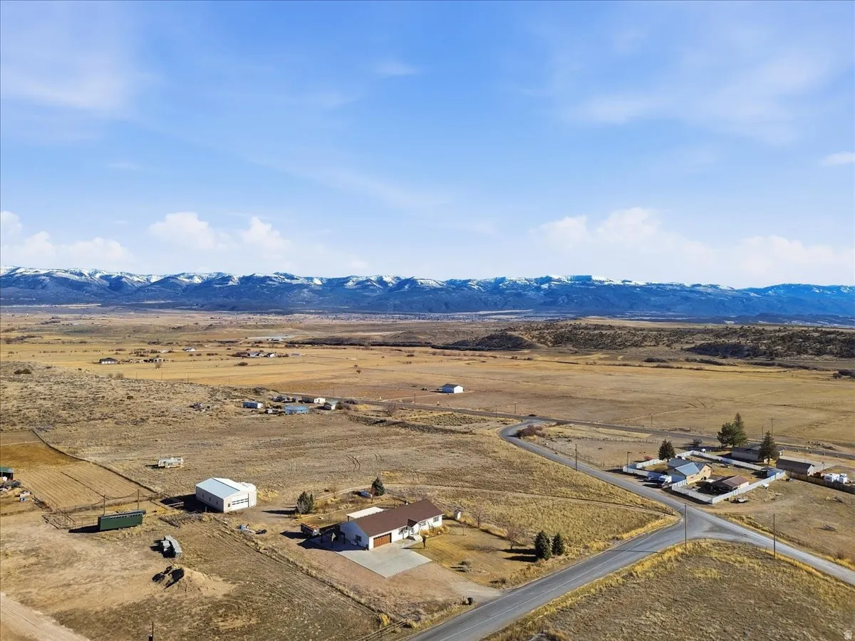 Aerial view of sparsely populated area featuring a mountainous background and a desert landscape