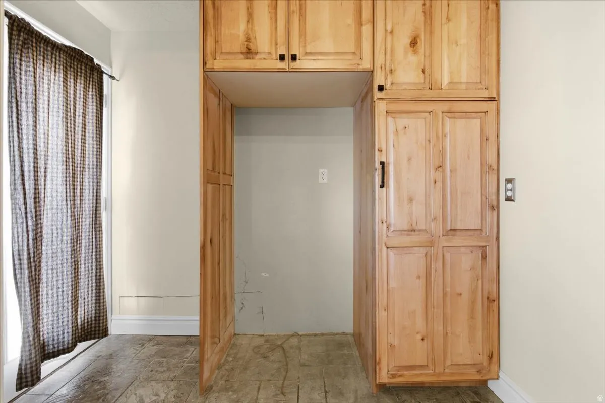 Kitchen featuring light wood finish cabinetry and baseboards