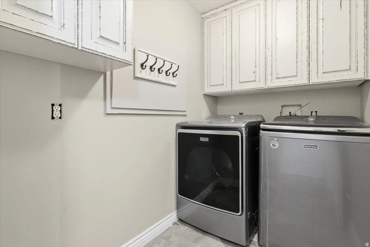 Laundry area with cabinet space and separate washer and dryer