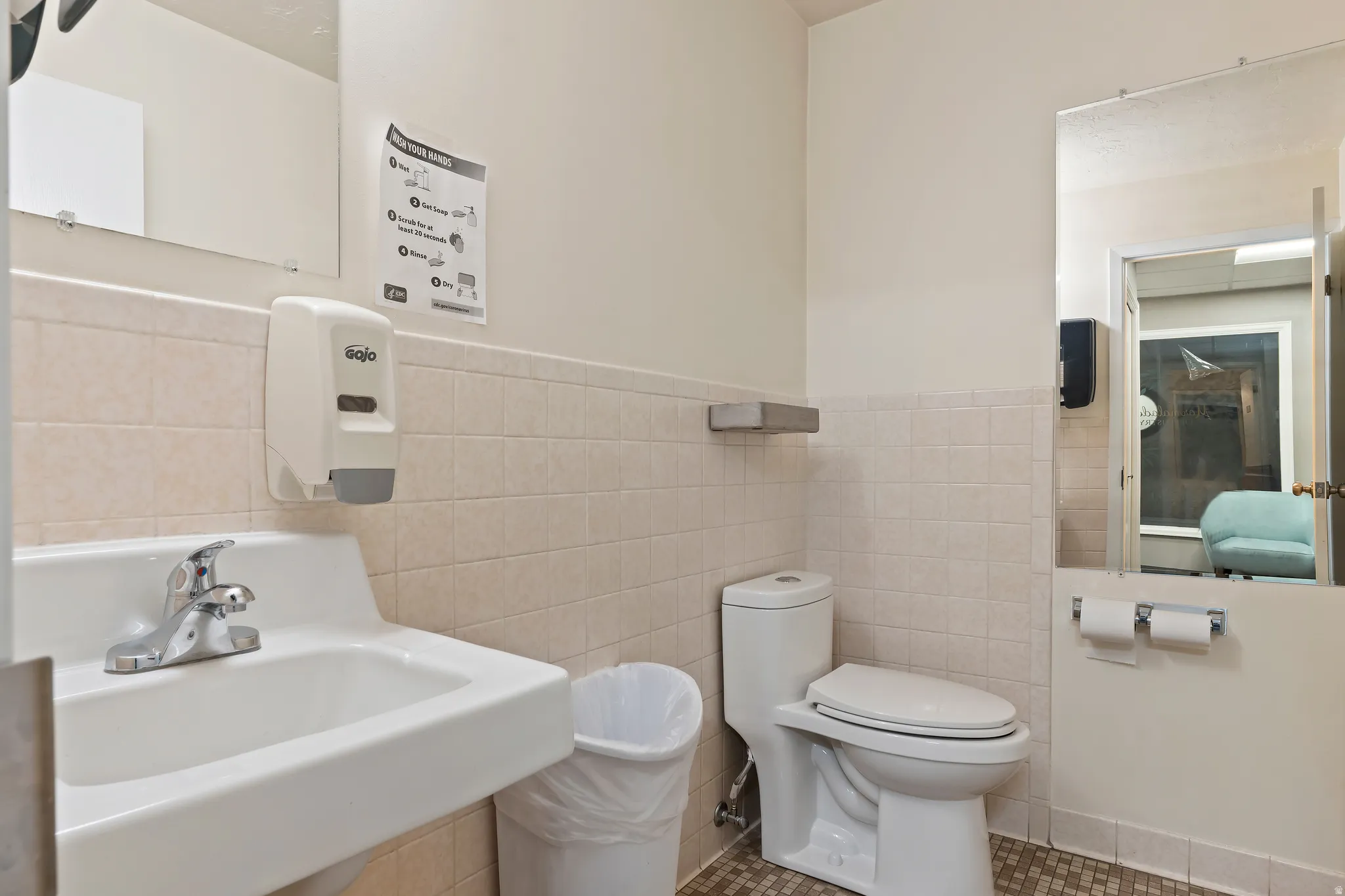 Bathroom featuring wainscoting and tile walls