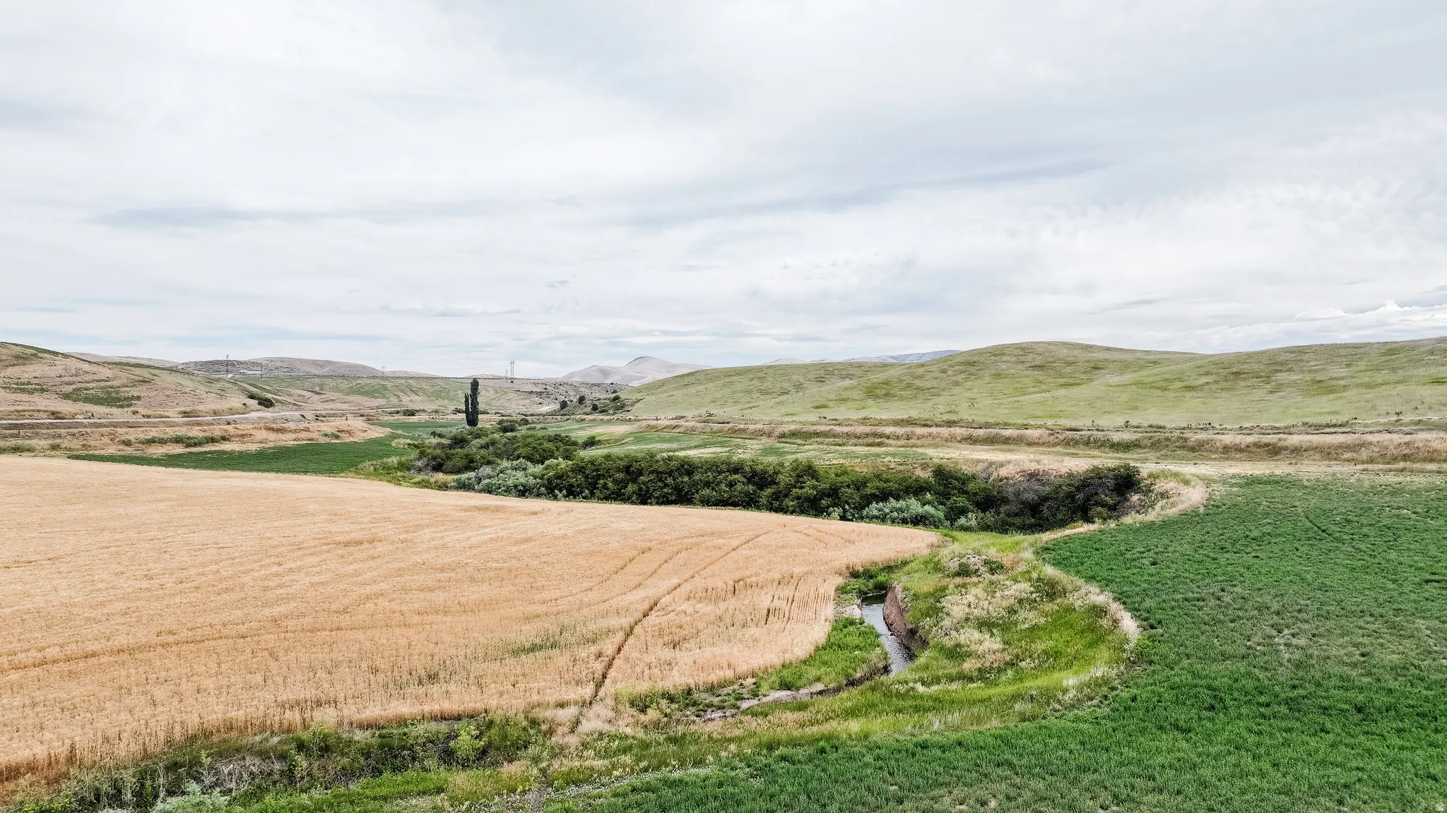 View of mountain backdrop with rural landscape
