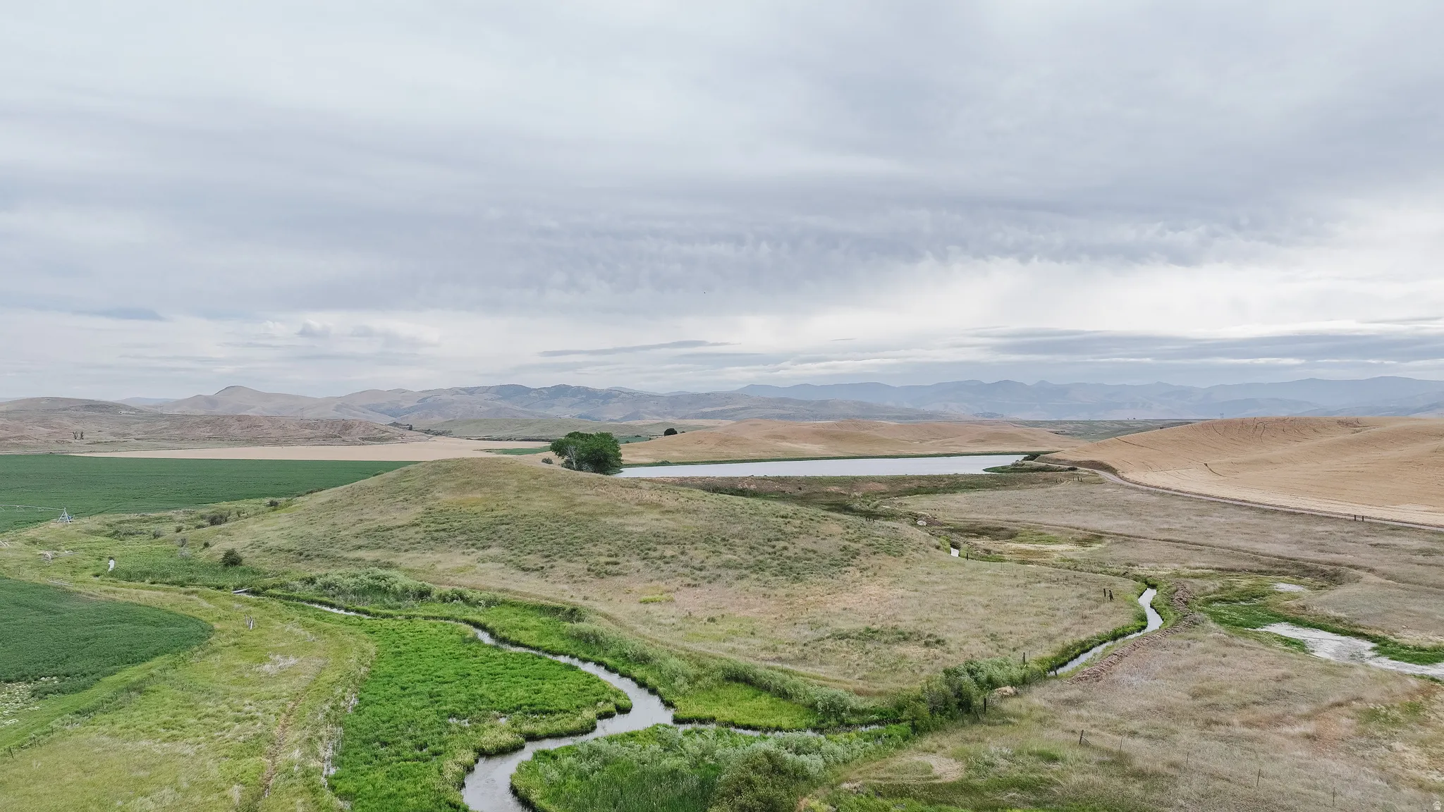 Overview of rural landscape featuring a water and mountain view