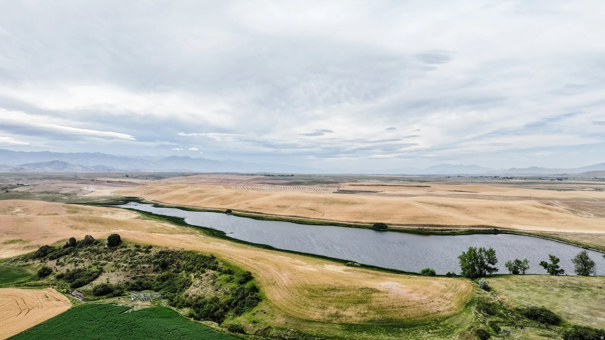 Overview of rural landscape featuring a water and mountain view