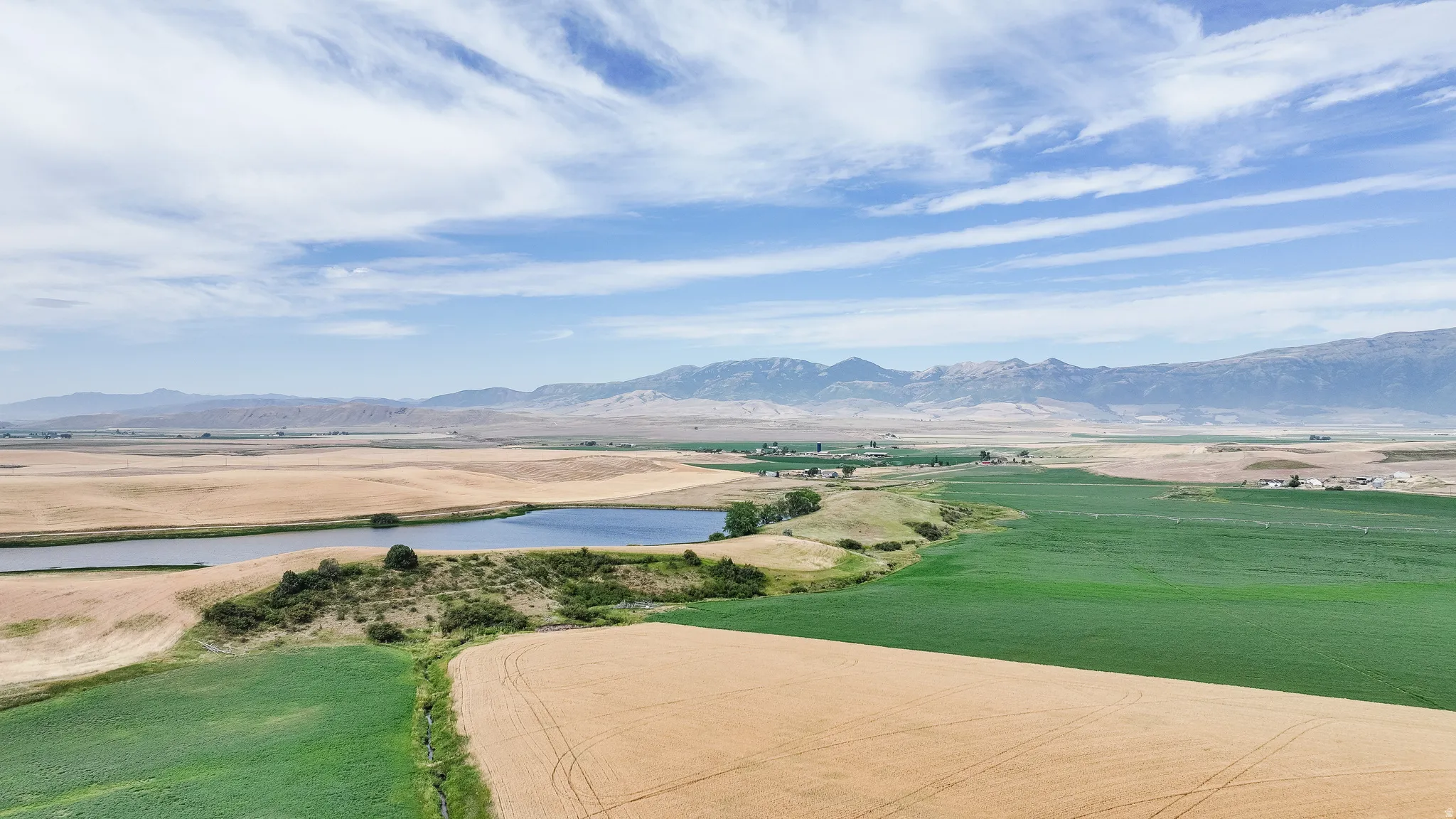 View of property's community featuring a water and mountain view and a view of rural / pastoral area