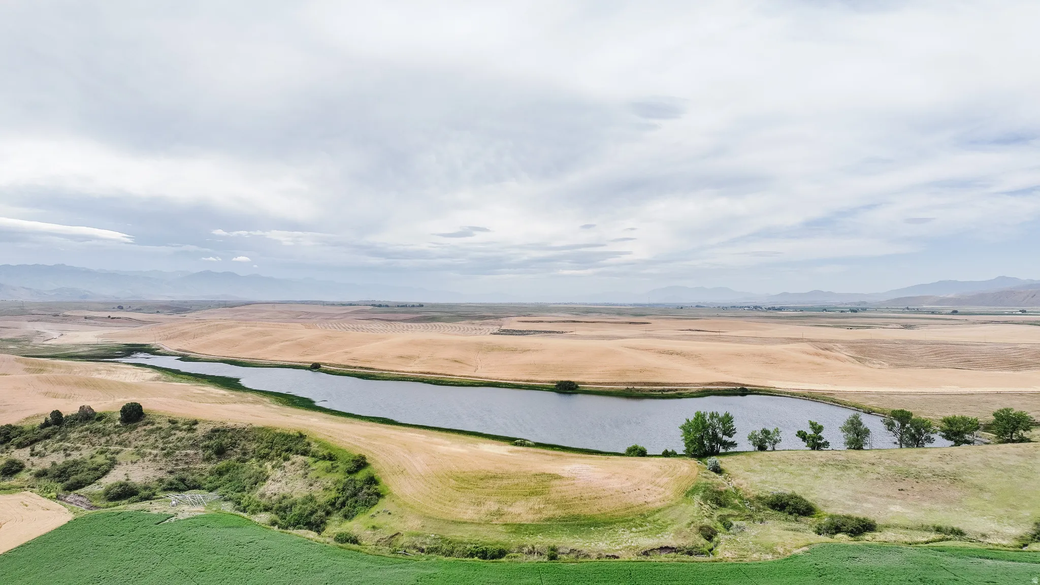 Aerial view of sparsely populated area featuring a water and mountain view