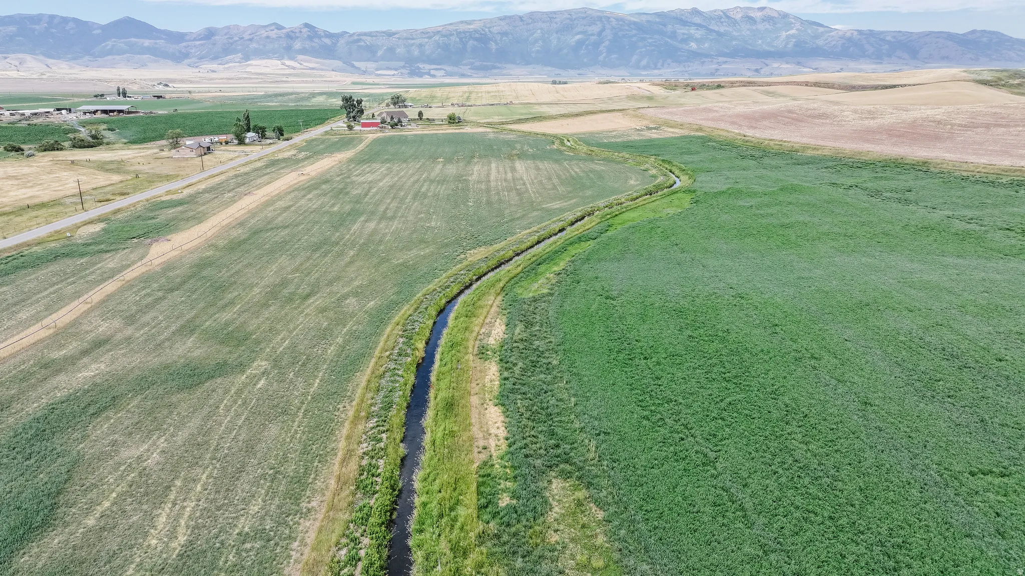 Aerial view of property and surrounding area with rural landscape and mountains
