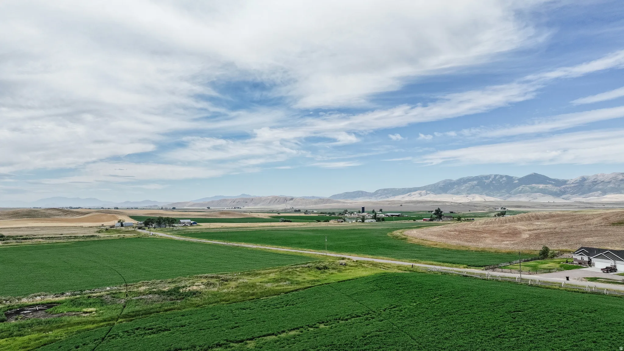 View of mountain backdrop featuring rural landscape and agricultural land