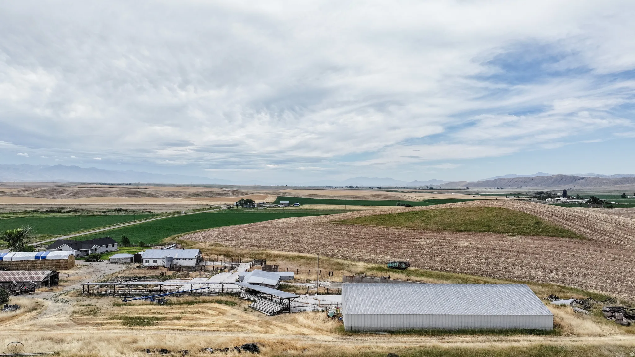 View of rural area featuring abundant farmland and a mountainous background