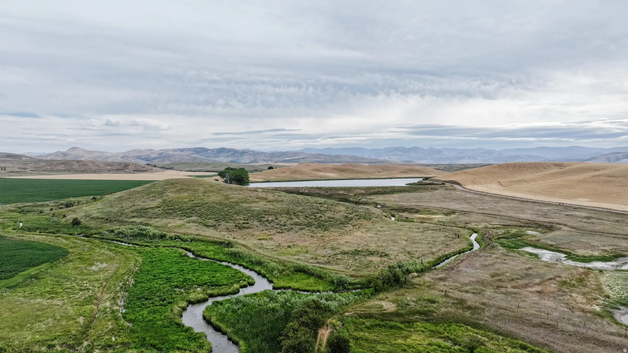 Aerial view of sparsely populated area with a water and mountain view