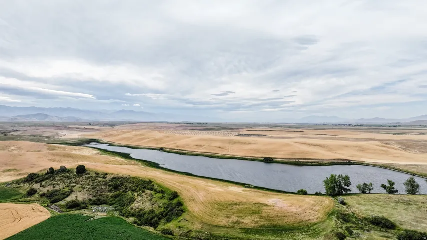Overview of rural landscape featuring a water and mountain view