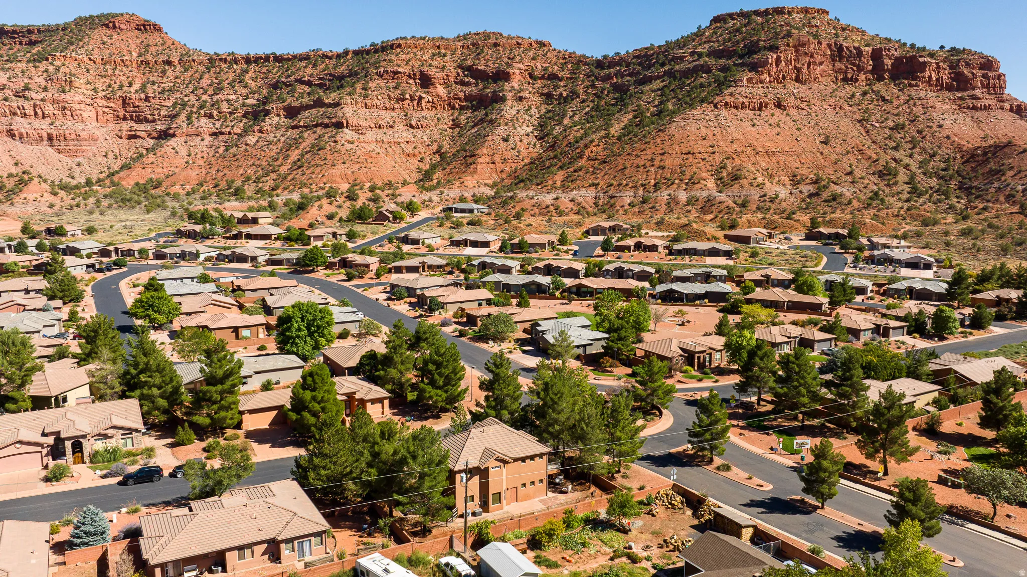 Aerial view of property's location featuring a mountain backdrop and nearby suburban area