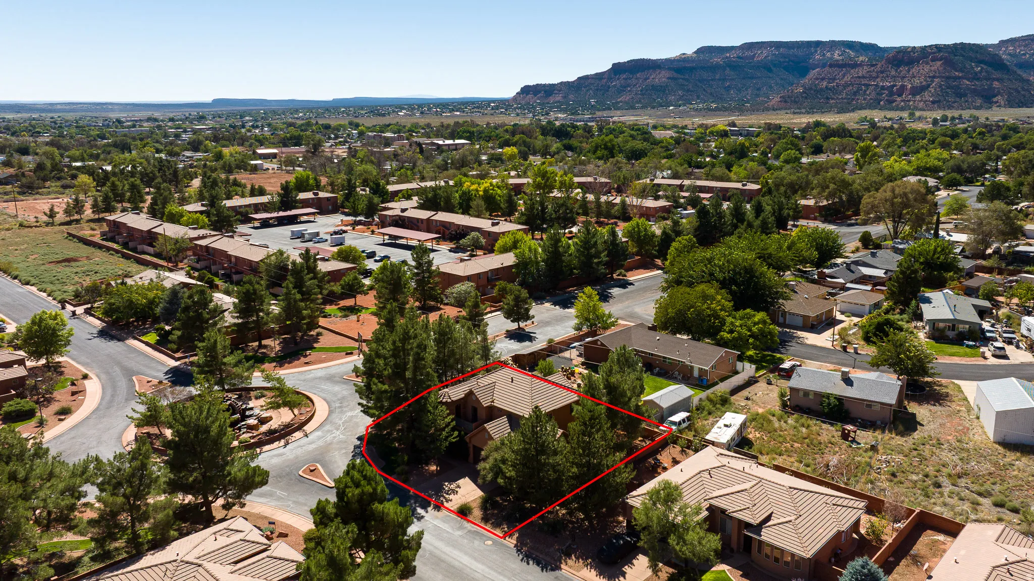 Aerial perspective of suburban area featuring property parcel outlined and mountains