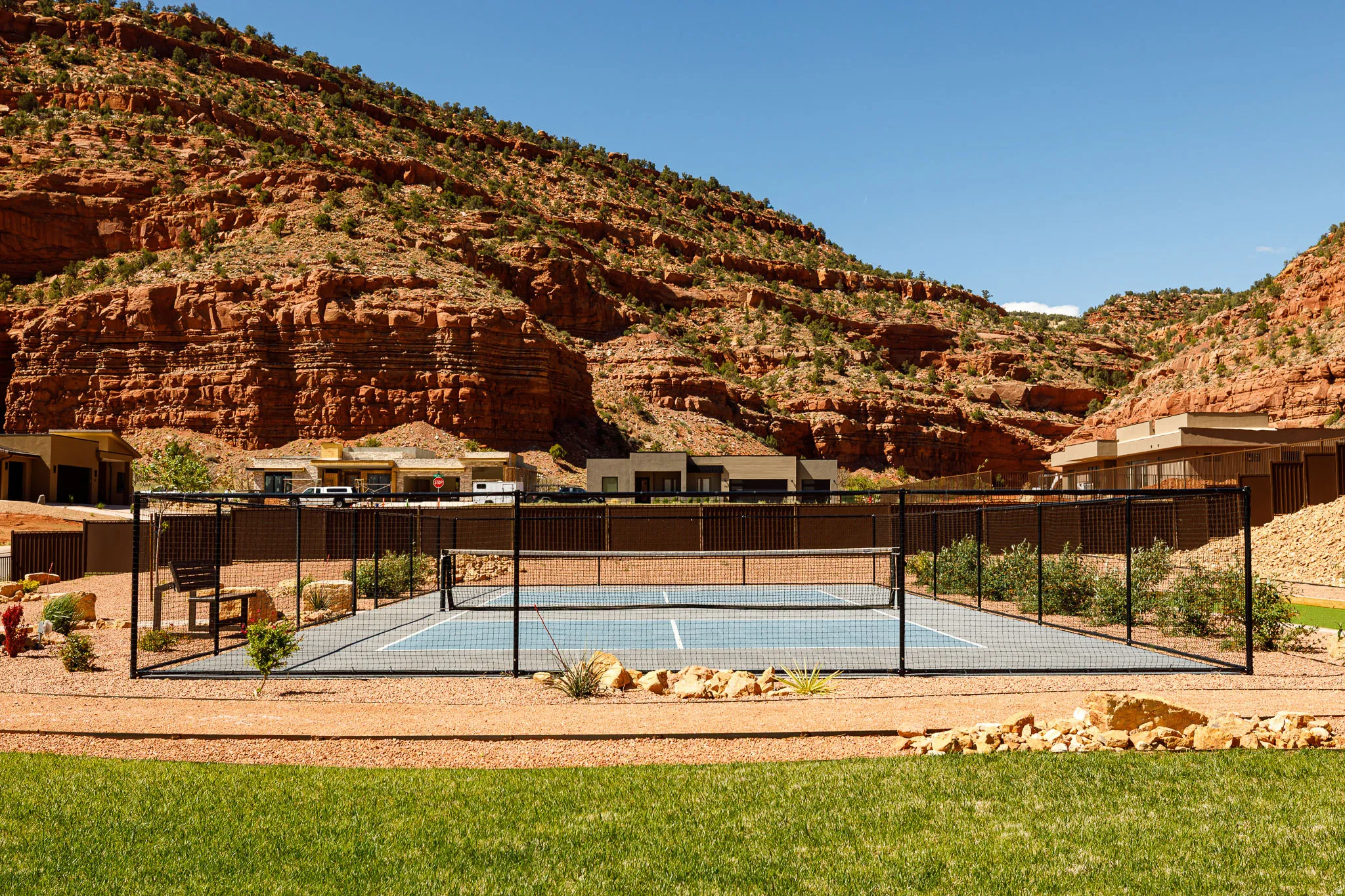 View of swimming pool with a tennis court, a mountain view, and patio surround