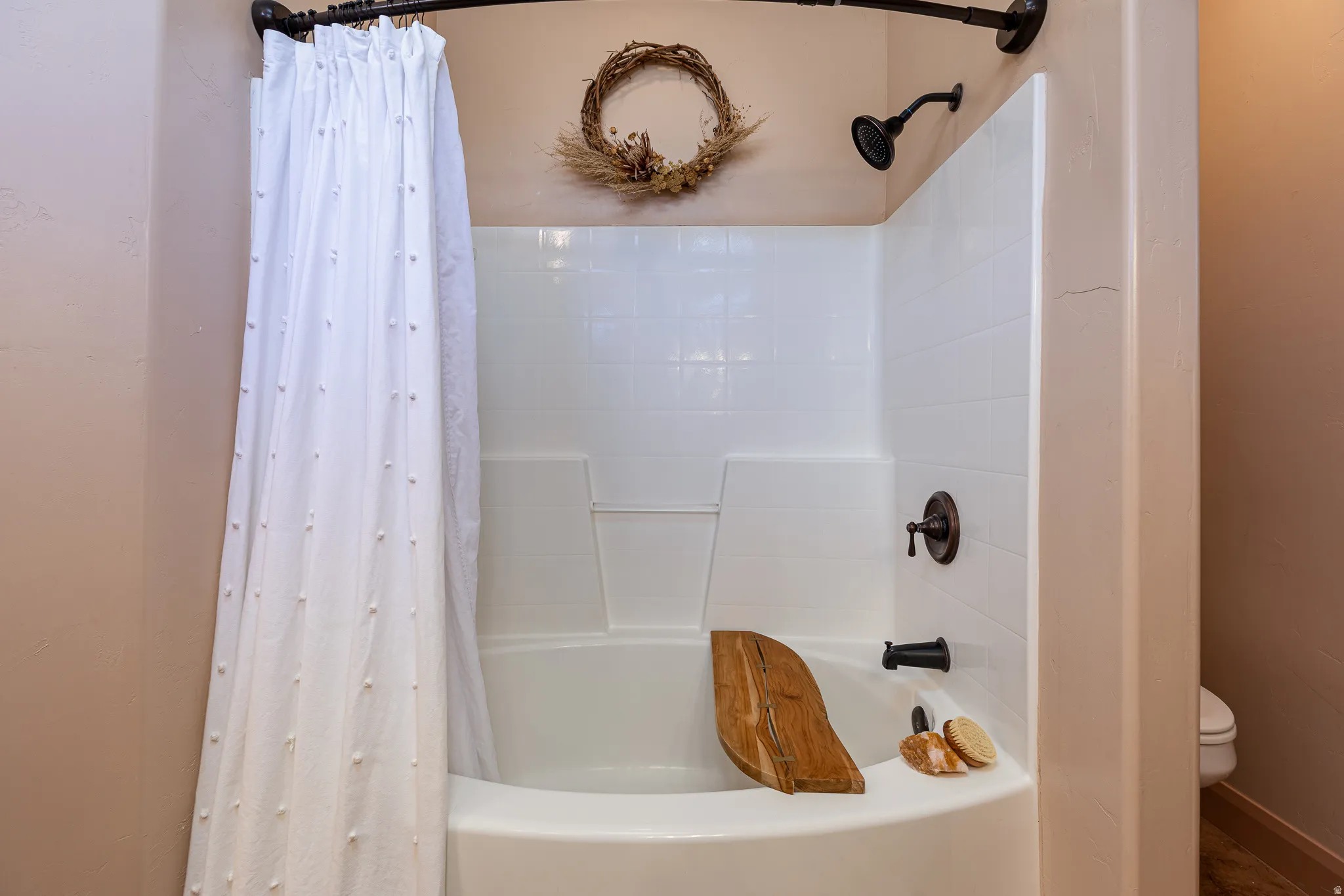 Full bathroom featuring shower / bathtub combination with curtain