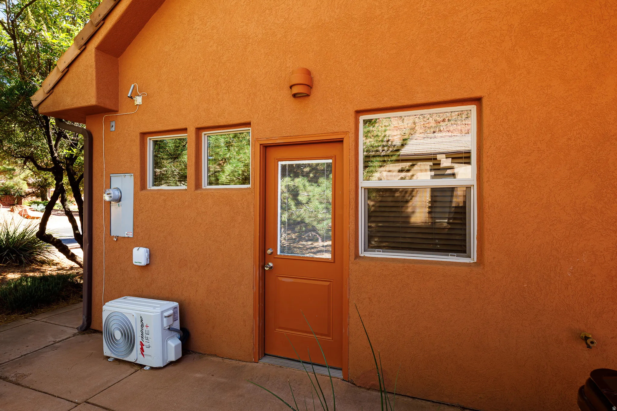 Property entrance featuring stucco siding