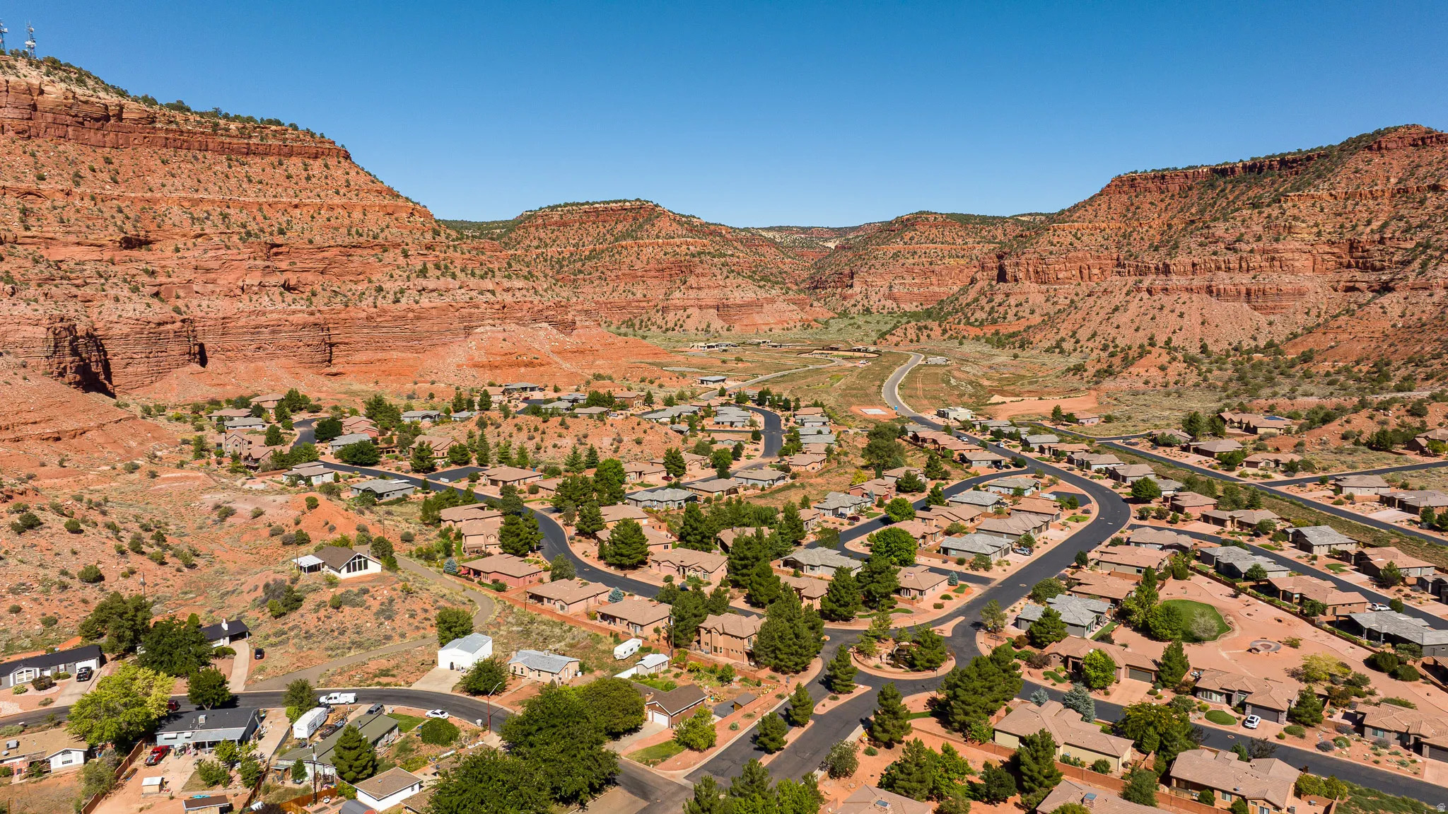 Aerial perspective of suburban area featuring a mountainous background