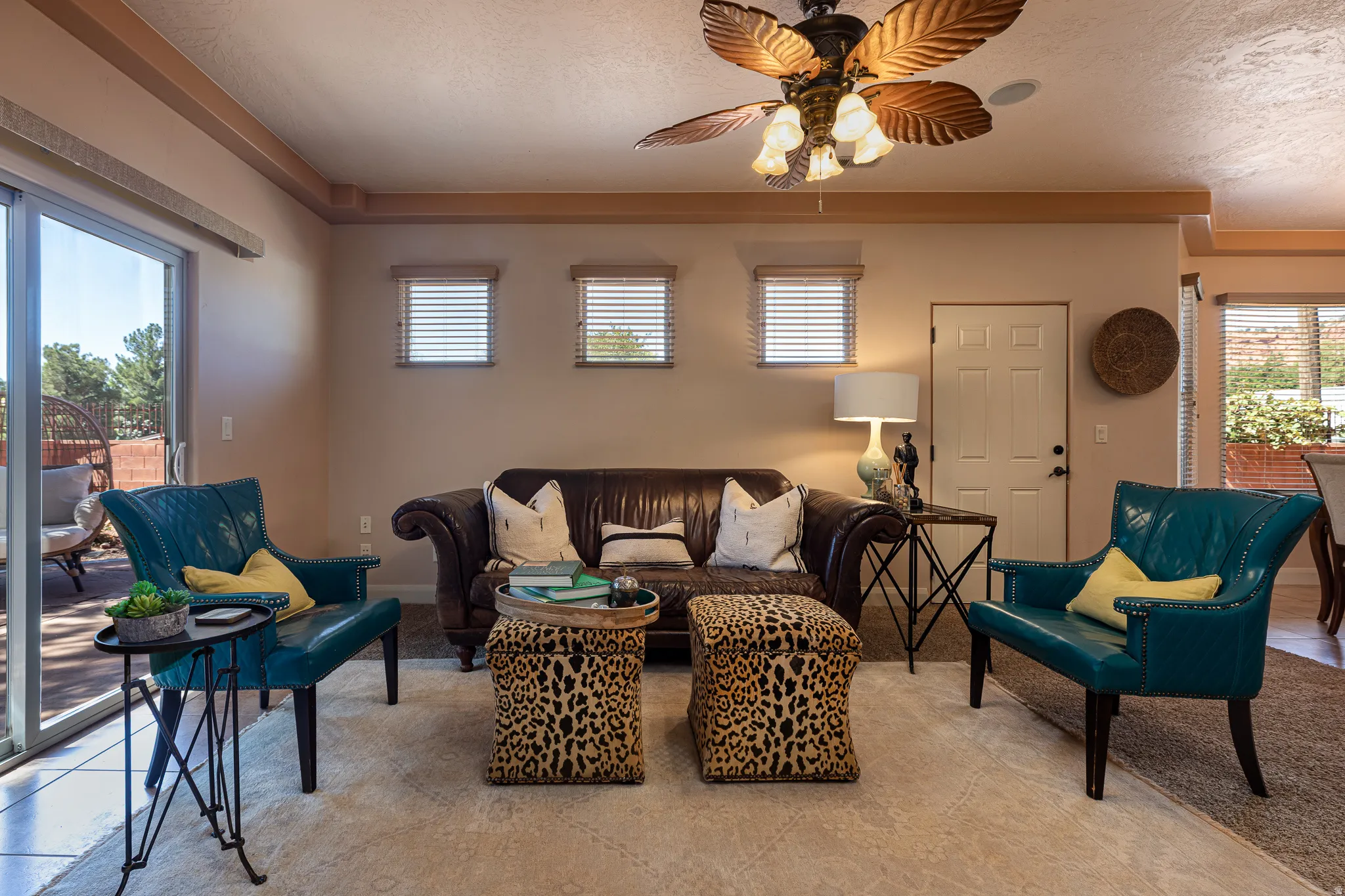 Living area featuring a ceiling fan and a textured ceiling