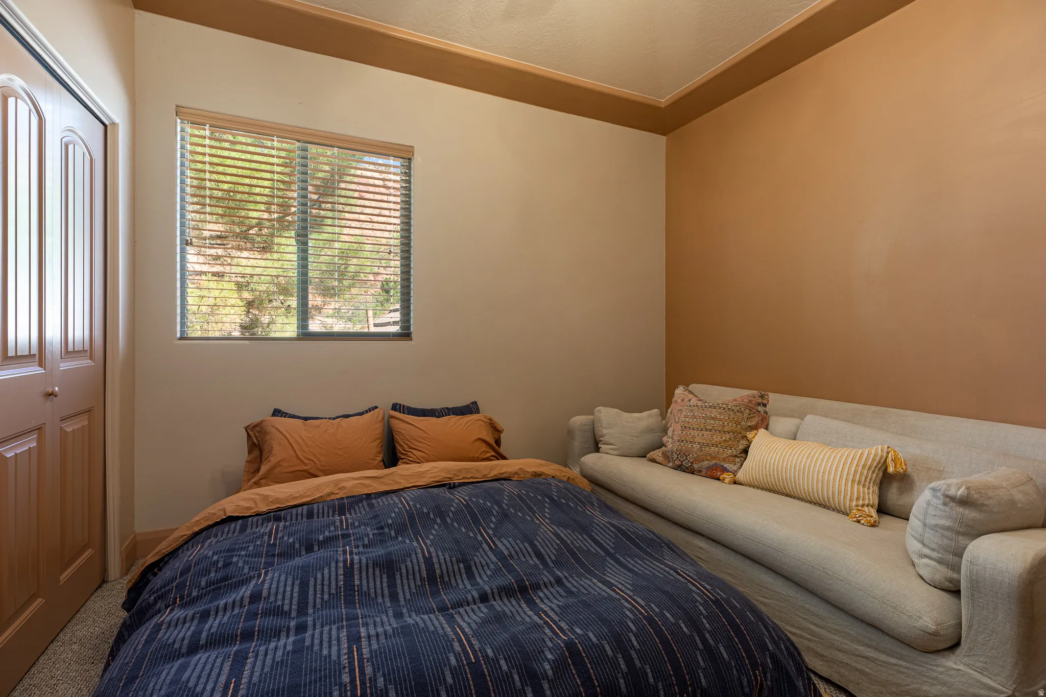 Bedroom featuring carpet and a closet