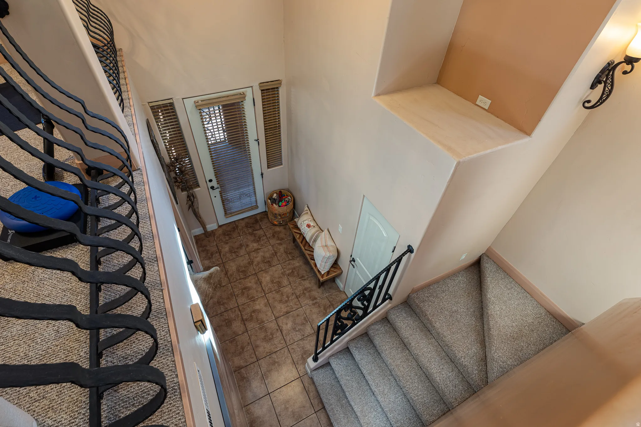 Stairs with tile patterned flooring and a high ceiling
