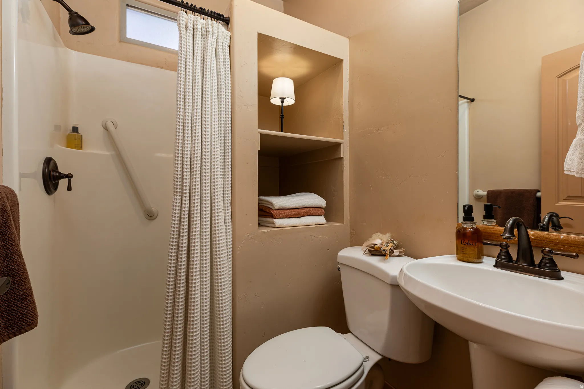 Full bath featuring a stall shower and toilet