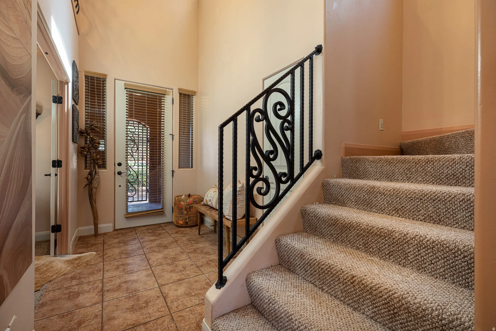 Foyer entrance with stairway and a high ceiling