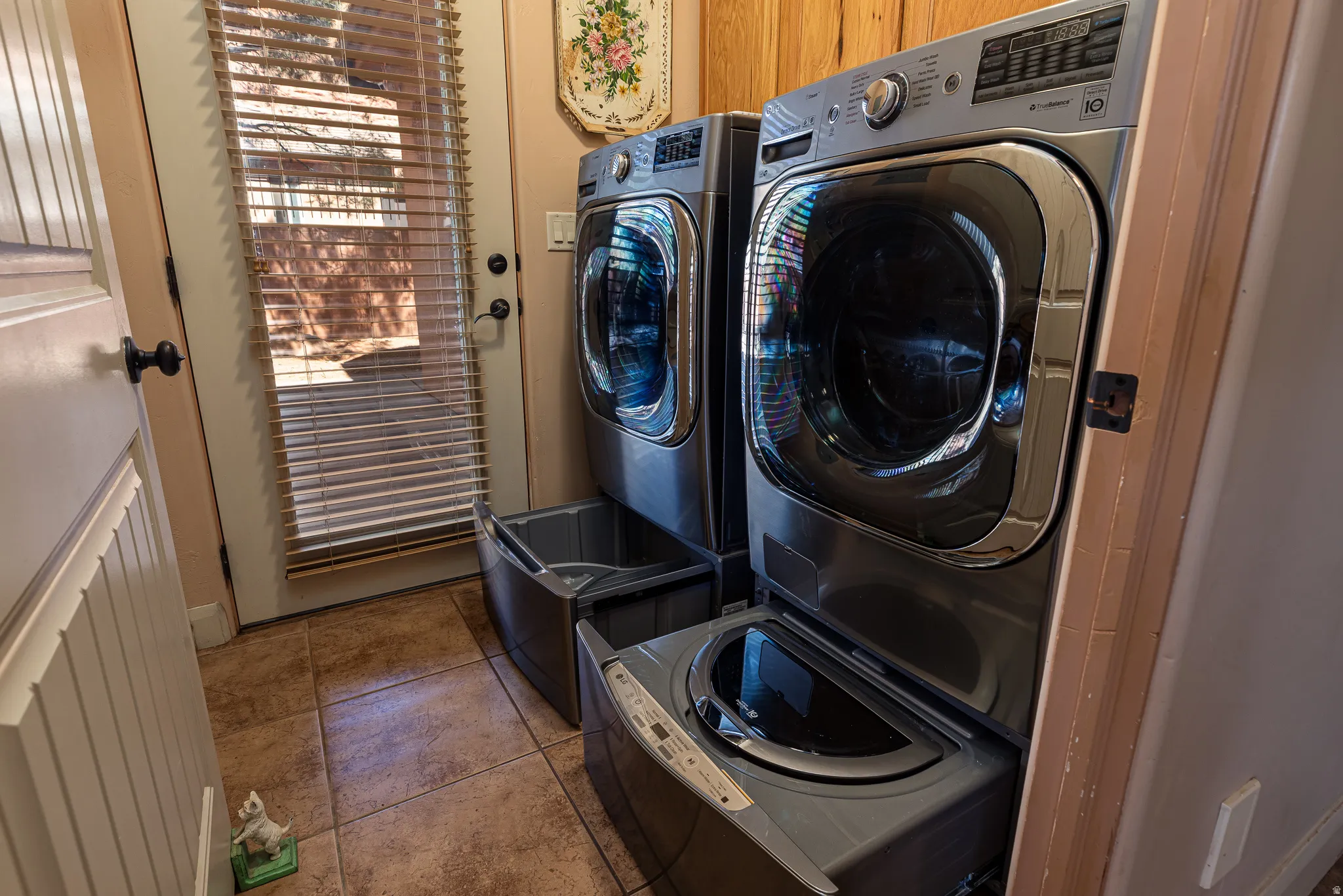 Laundry area featuring independent washer and dryer and tile patterned floors