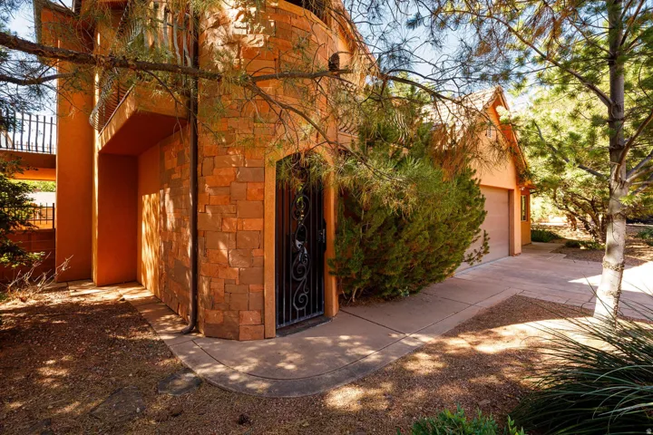 View of property exterior featuring stone siding and stucco siding