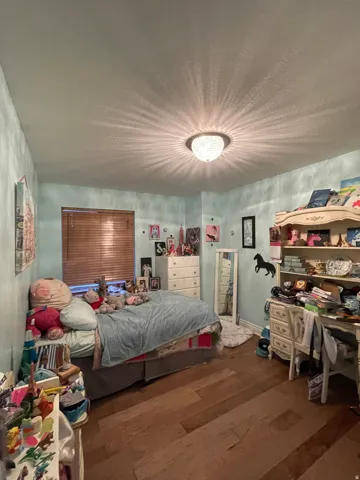 Bedroom featuring dark wood-style flooring