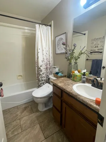 Bathroom featuring vanity and shower / bath combo