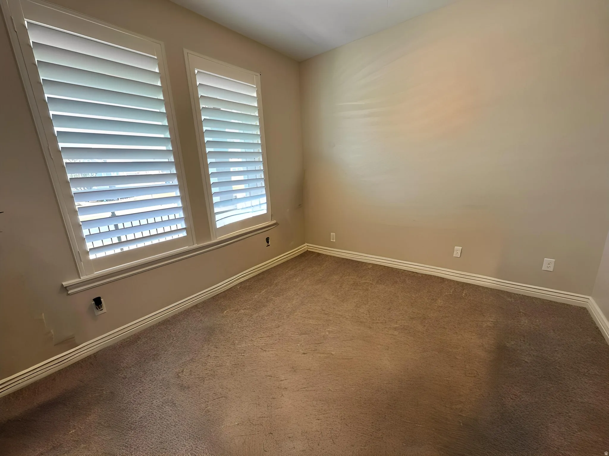 Unfurnished room with carpet flooring and baseboards