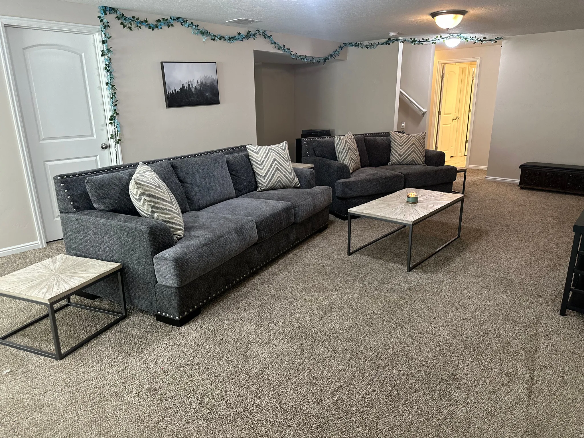 Living area featuring carpet flooring and baseboards