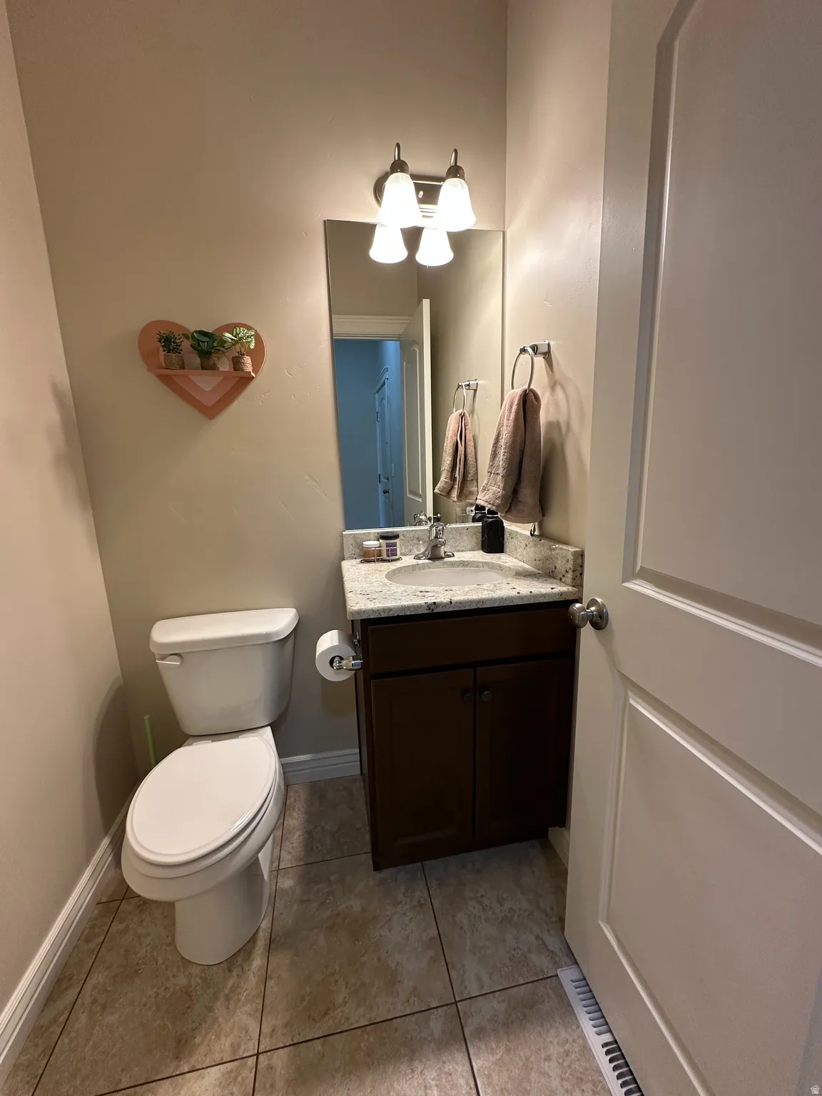 Bathroom with vanity and light tile patterned floors